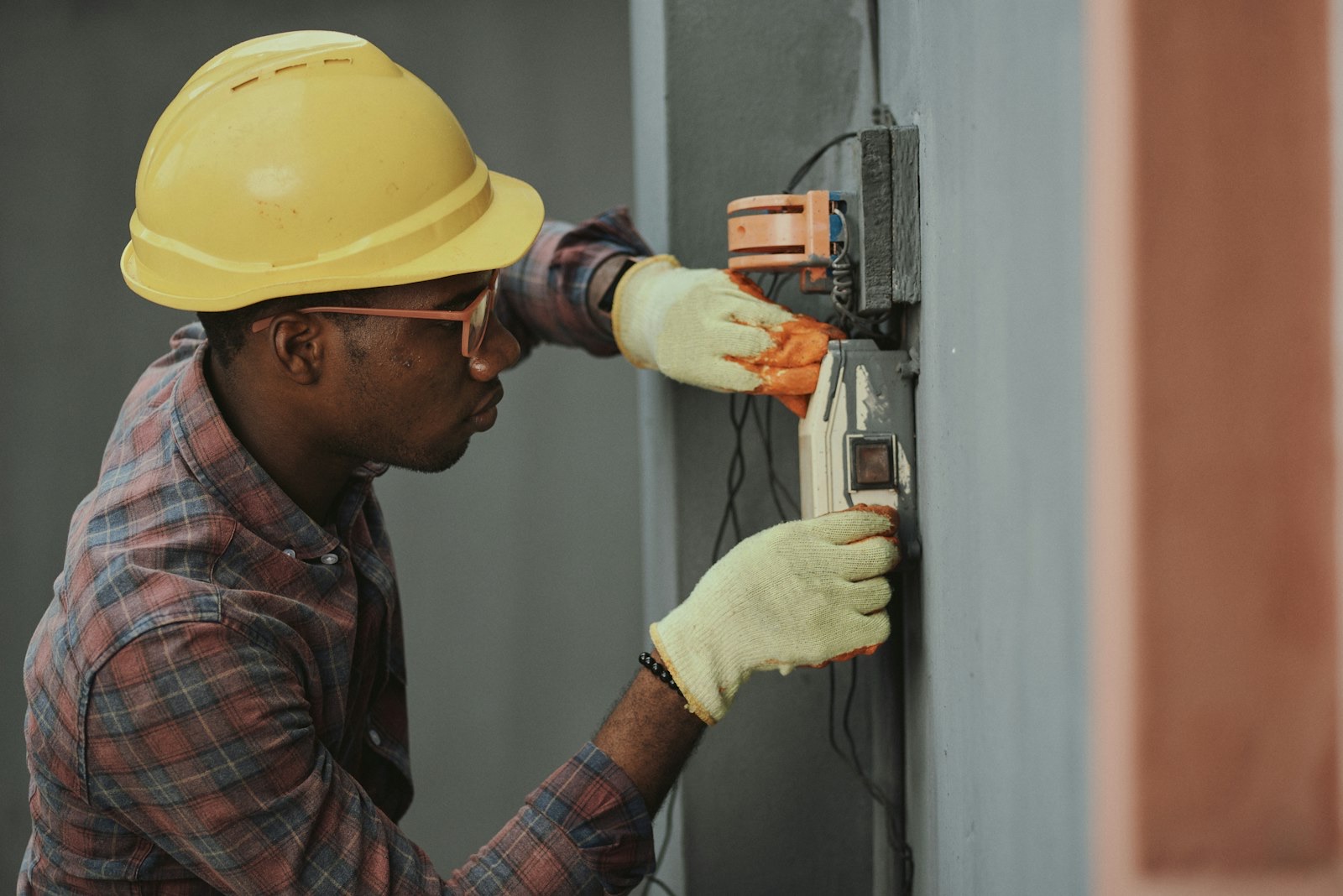 Worker installing a fixing of the kind proof tested on a scaffold anchor tie