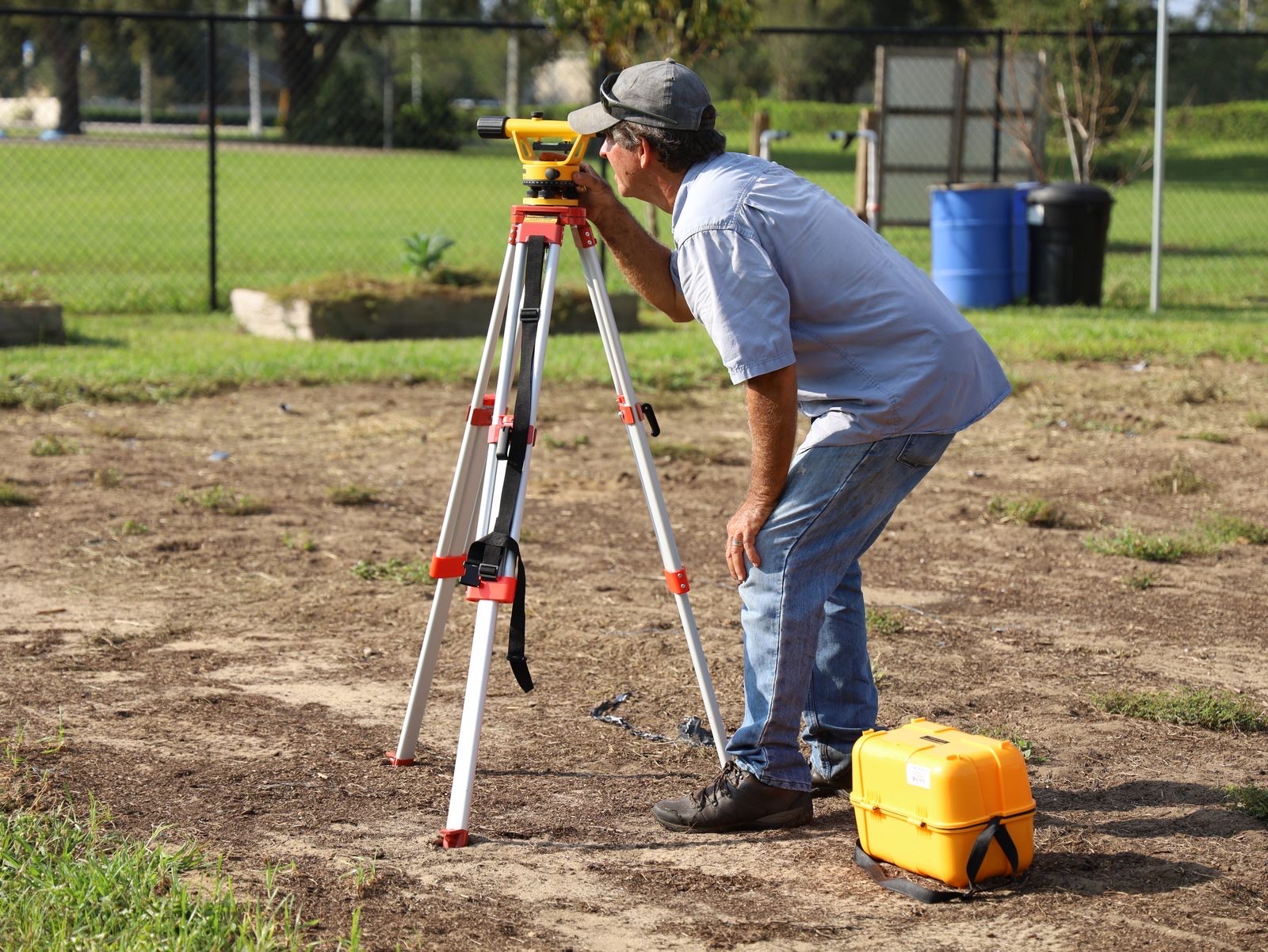 Surveyor recording measurements of a building